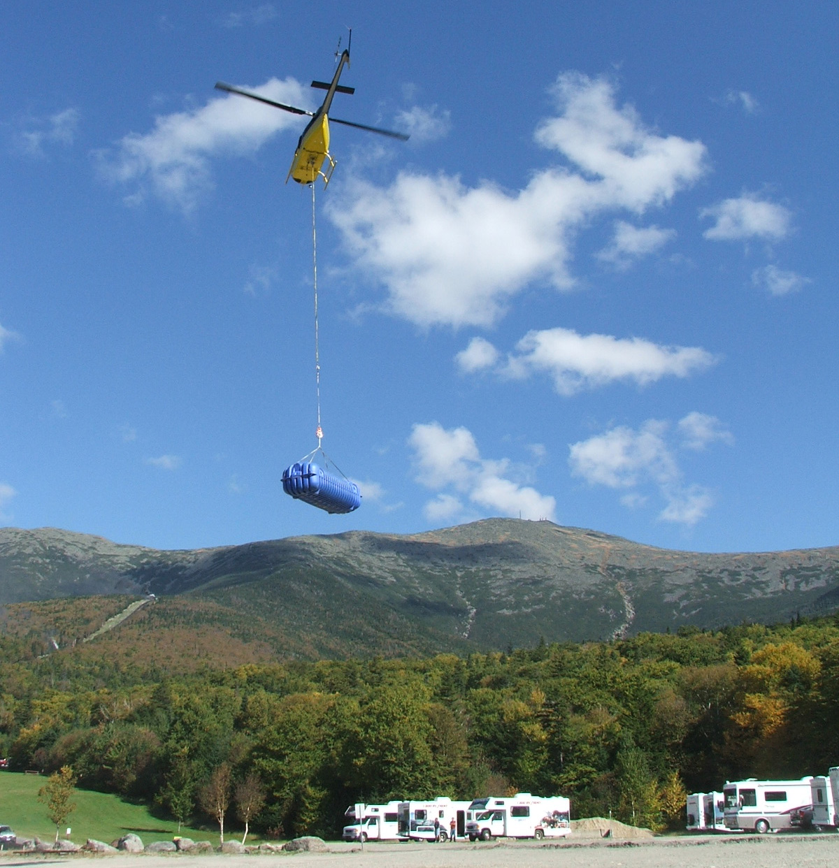 Helicopter Delivering a water tank, by Water Industries, LLC.