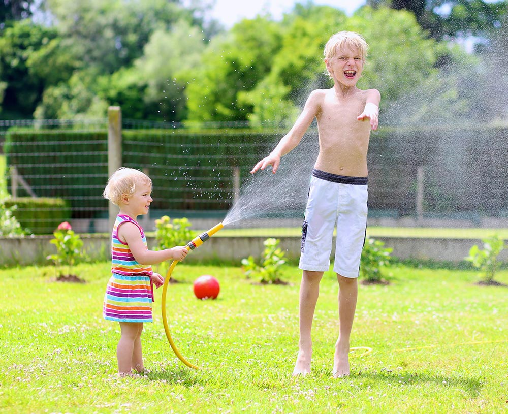 Children playing with a water hose
